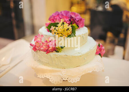 Wedding cake decorated with flowers Stock Photo