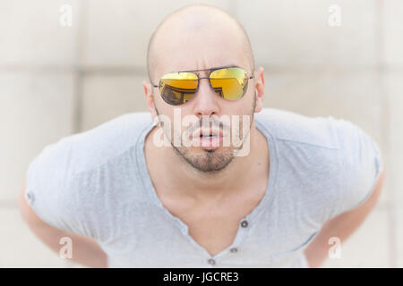 Portrait of a man wearing sunglasses looking up Stock Photo