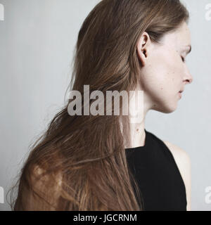 Portrait of a beautiful woman with long hair looking sideways Stock Photo