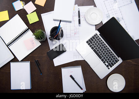 top view of laptop, smartphone, notepads and office supplies on tabletop at workspace Stock Photo