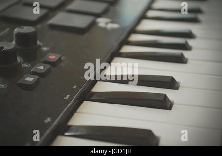 Piano or electone midi keyboard, electronic musical synthesizer white and black key. Vintage effect, instagram filter style. Stock Photo
