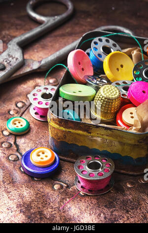 Old-fashioned metal box with buttons and threads Stock Photo