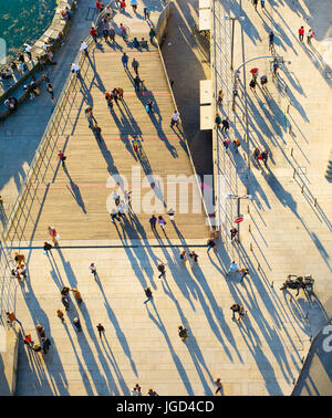 Birds-eye view of a people walking on the street at sunset Stock Photo