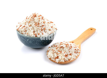 rice in a ceramic cup and wooden spoon isolated on white background Stock Photo