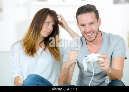 Annoyed Girlfriend Waiting for Boyfriend To Stop Playing Video-games Stock  Photo - Image of game, gamer: 100430632