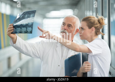 two doctors analyzing brain xrays on computer Stock Photo