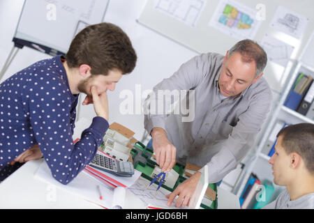 teacher helps students of math class Stock Photo