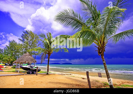 Cambodia Sihanoukville Islands amid monsoon cumulus clouds and blue skies palm trees jetski Stock Photo