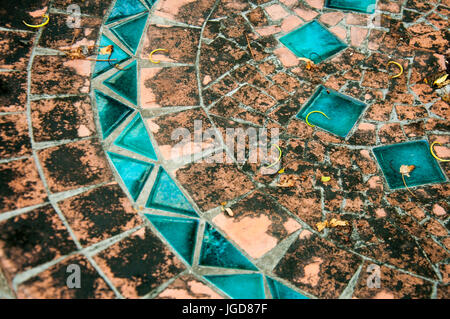 A mosaic element on an old table, orange and blue. Stock Photo