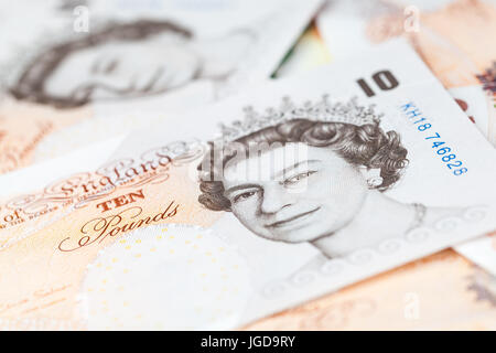 Ten pound notes of the Bank of England lay on a table. Close-up photo with selective focus Stock Photo