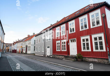 Traditional Scandinavian wooden houses stand along the street. Trondheim, Norway Stock Photo