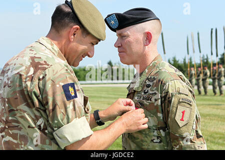 British Maj. Gen. Doug Chalmers, guest speaker and III Corps deputy commander for support, awards Brig. Gen. Patrick D. Frank, 1st Infantry Division and Fort Riley acting senior commander, with a Legion of Merit Medal during a Victory with Honors ceremony June 27 at the division’s headquarters. Frank received the medal for his actions while serving as the 1st Inf. Div. deputy commanding general (rear) and Fort Riley acting senior commander since October 2016 with the deployment of the 1st Inf. Div. Headquarters to Operation Inherent Resolve. (Chad L. Simon, 1st Inf. Div. Public Affairs) Stock Photo