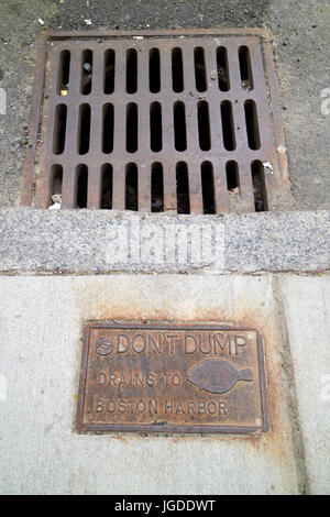 dont dump drains to boston harbor sign next to street level storm water drain Boston USA Stock Photo