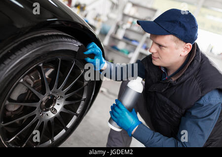 Man washing car tyres Stock Photo