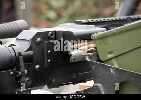 bullet belt loaded into general purpose machine gun weapon mounted on a british army vehicle uk Stock Photo
