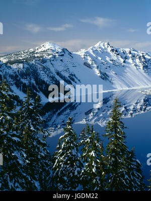 USA, Oregon, Crater Lake National Park, Winter snow on west rim of Crater Lake with The Watchman (left) and Hillman Peak (right). Stock Photo