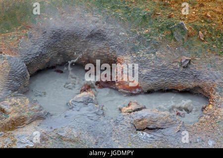 Bubbling mud in mudpot / mud pool at Seltun, geothermal field showing volcanic fumaroles, mud pots and hot springs, Reykjanes Peninsula, Iceland Stock Photo
