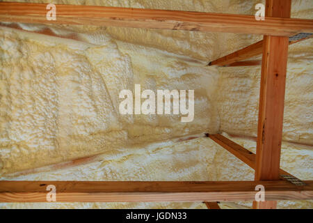 Foam plastic insulation installed in the sloping ceiling of a new frame house. Stock Photo