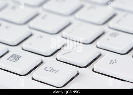 Computer keyboard closeup, white grey, focus on Ctrl key Stock Photo