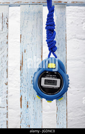 Sports equipment - Blue Digital electronic Stopwatch on a vintage wooden background Stock Photo