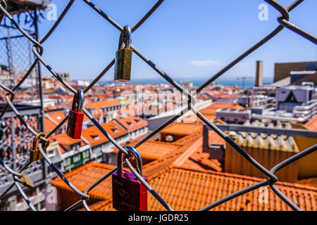 Locks as a proof of love attached to a fence over the rooftops of Lisbon - LISBON - PORTUGAL 2017