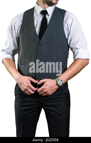 A young businessman in a white shirt with a tie is holding his hands on his belt. A guy, a hipster in a gray waistcoat and a shirt with a rolled up sl Stock Photo