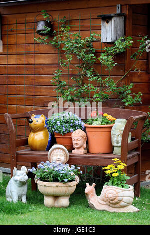 Summer house with flowers and garden figures Stock Photo - Alamy