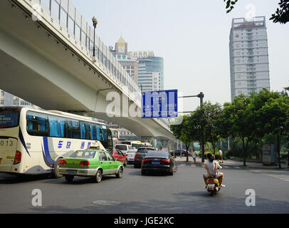 Chengdu, China - Aug 20, 2016. People and vehicles on street in Chengdu, China. Chengdu was the 5th-most populous agglomeration in China, with 10,484, Stock Photo