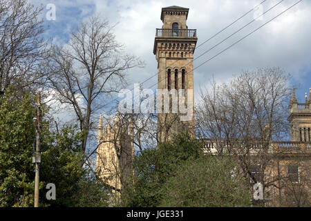 sylvan view of trinity college Tower and Park Parish Church, Park Circus, Glasgow park trees branches Stock Photo