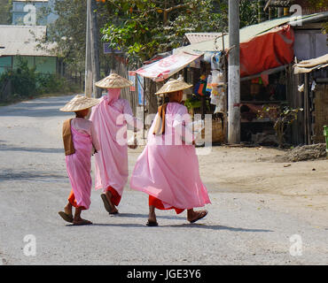 Yangon, Myanmar - Feb 21, 2016. Buddhist nuns walking for morning alms on street in Yangon, Myanmar. Yangon is the largest city in Myanmar (formerly B Stock Photo