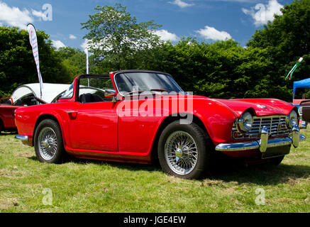 Side view of a bright red Triumph sports car on show at a classic car event in Wales, UK Stock Photo