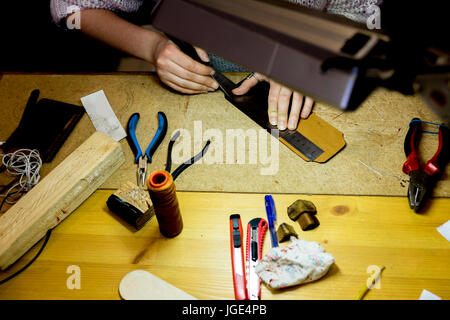 Hands of Caucasian man using ruler in workshop Stock Photo