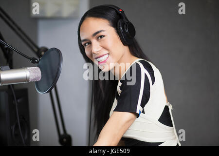 Smiling Thai transgender woman at microphone Stock Photo