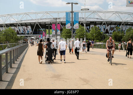 View of the stadium and families at the entrance of the Queen Elizabeth Olympic Park  in Stratford, Newham East London England UK    KATHY DEWITT Stock Photo