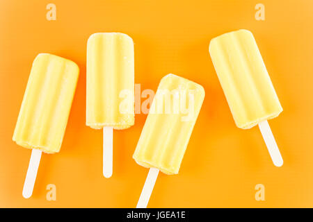 Multicolored fruit ice cream bars on colored background. Stock Photo