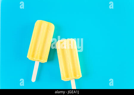 Multicolored fruit ice cream bars on colored background. Stock Photo