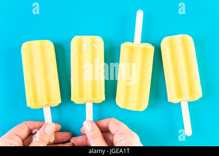 Multicolored fruit ice cream bars on colored background. Stock Photo