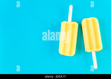 Multicolored fruit ice cream bars on colored background. Stock Photo