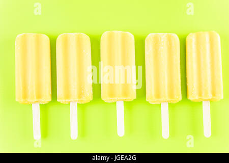 Multicolored fruit ice cream bars on colored background. Stock Photo