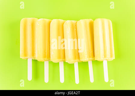 Multicolored fruit ice cream bars on colored background. Stock Photo