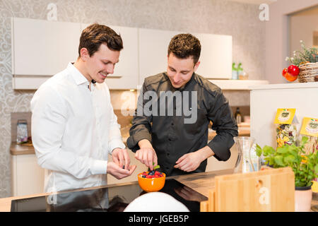 Cook gives a cooking course Stock Photo