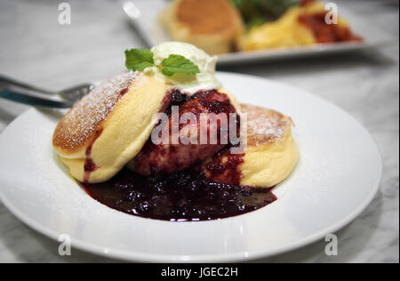 The photo showing a Japanese style pancake is photographed in a restaurant 'A happy pancake'. Stock Photo