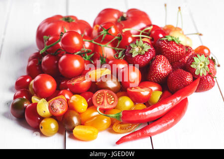 Red vegetables and fruit on white wood Stock Photo