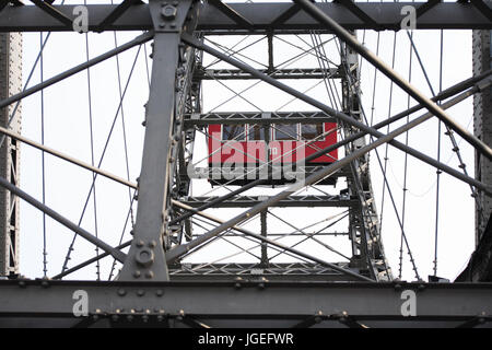 Cable car of ferris wheel between interweaving metal fasteners Stock Photo