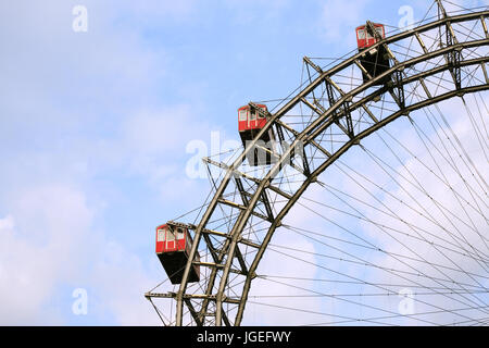 Ferris wheel closeup on background with blue sky and clouds Stock Photo