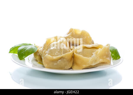 Boiled manti with meat on a plate Stock Photo