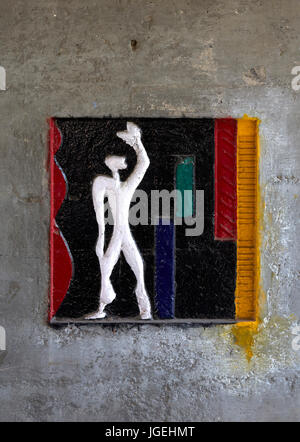 Brightly colored painted  'Modular Man' stamped onto concrete wall. Chandigarh College of Architecture, Chandigarh, India. Architect: Corbusier , 1961 Stock Photo