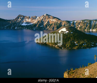 USA, Oregon, Crater Lake National Park, Sunrise on Crater Lake and Wizard Island with Garfield Peak  rising above Crater Lake; from Merriam Point. Stock Photo