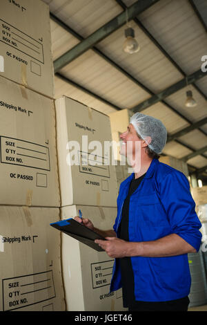Worker smiling in factory Stock Photo - Alamy