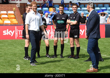 Prince Harry meets with local players as former Leeds Rhino rugby league player Kevin Sinfield (right) looks on during his visit to the Headingley Carnegie Stadium in Leeds, on the first day of his two-day visit to the city. Stock Photo